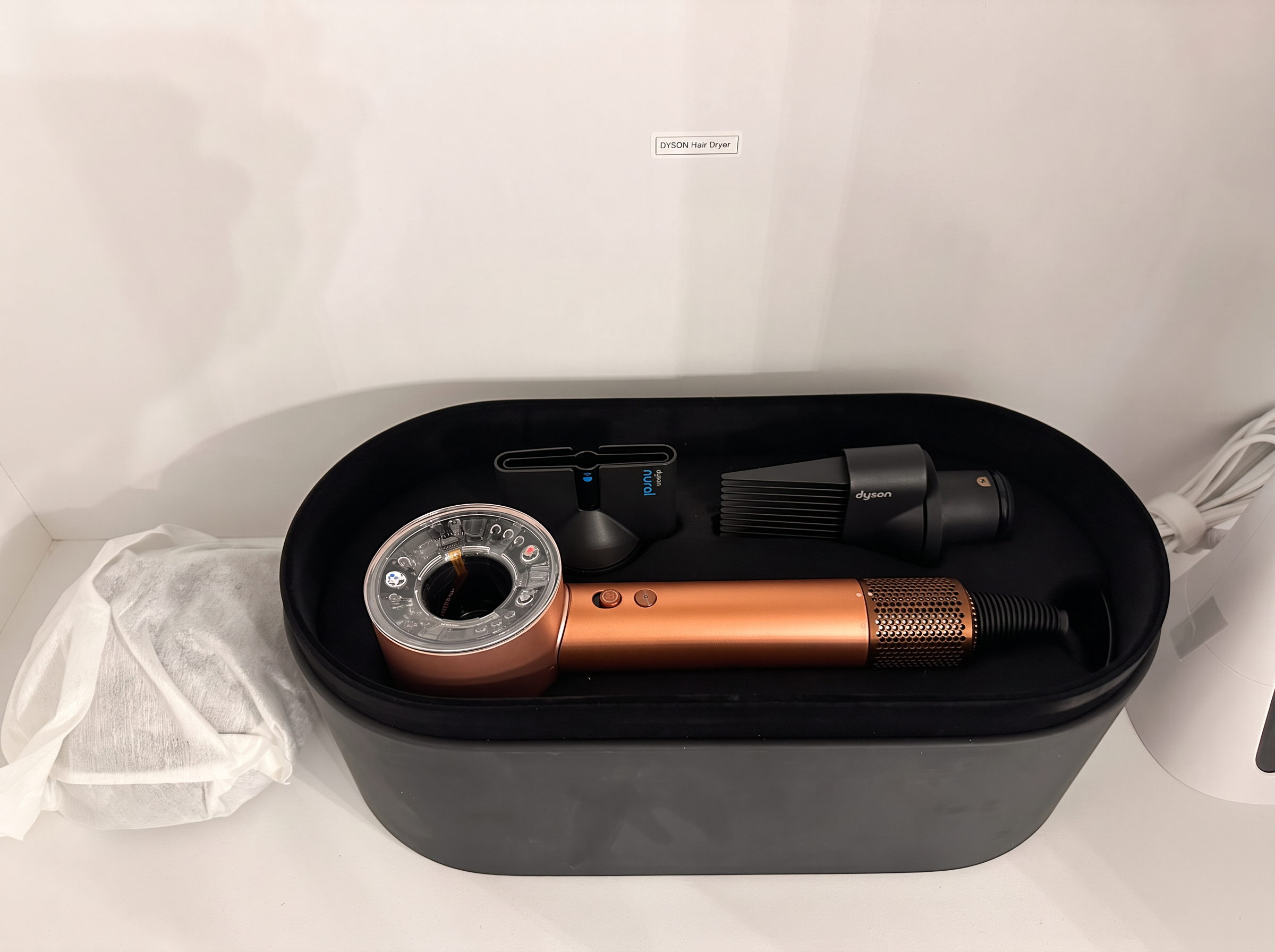 Dyson hair dryer in its case in the primary en suite