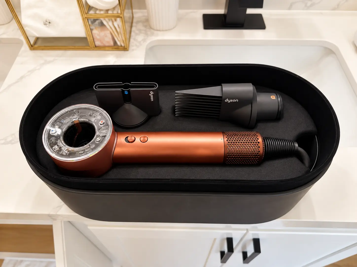 Dyson Supersonic hair dryer with attachments provided in the bathroom